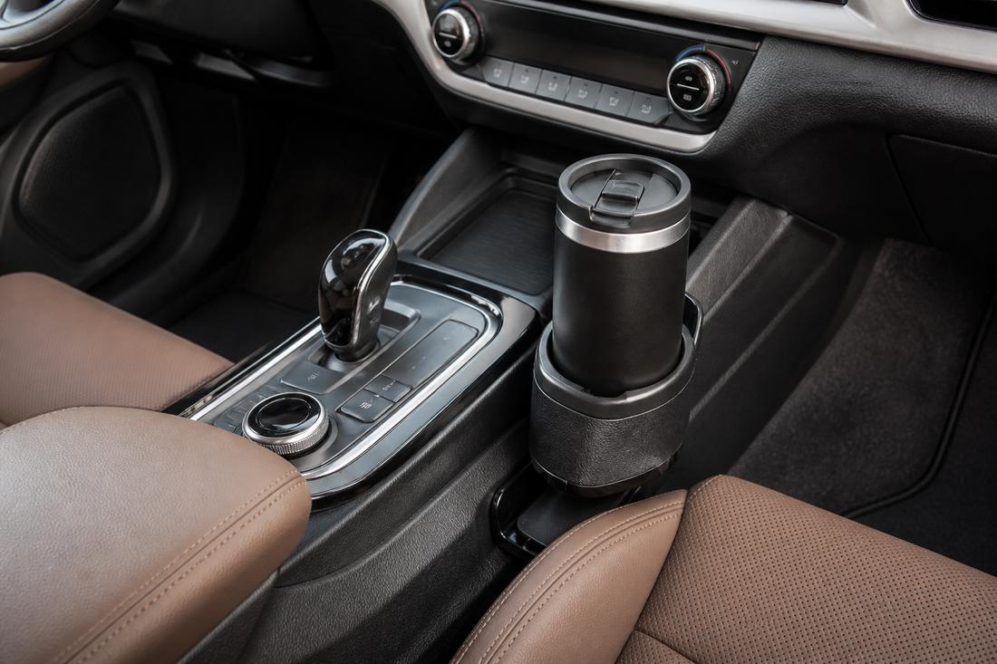 Car cup holder extender installed in a vehicle center console and holding a reusable insulated drink container