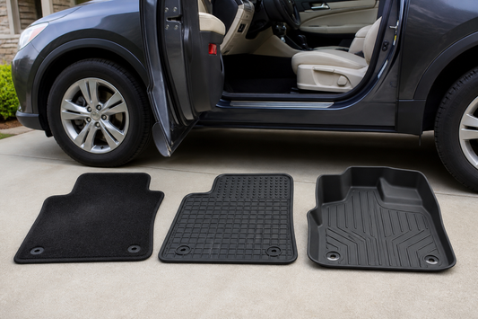 Carpet, rubber, and molded TPE floor mats arranged beside an open vehicle