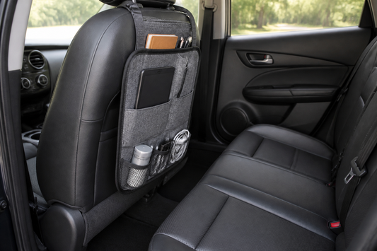 Compact car seat-back organizer installed behind a front seat with clear rear passenger legroom and accessible seatbelts